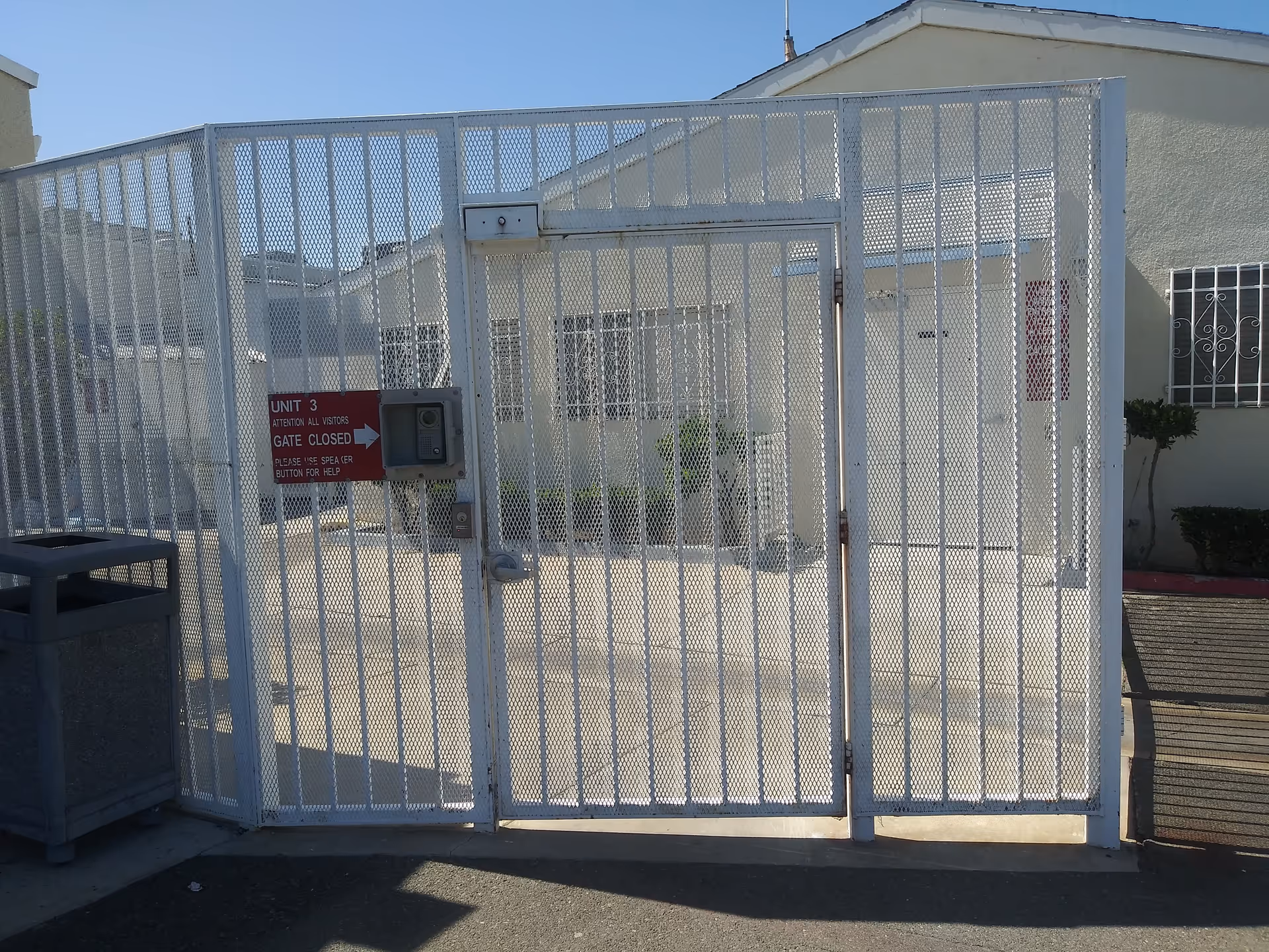 Metal gated entrance to a senior care facility, with a sign reading Unit 3 gate closed.