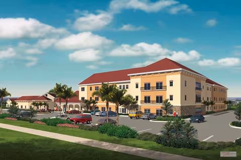A senior living facility with red roof, tan walls, palm trees, and a parking lot.