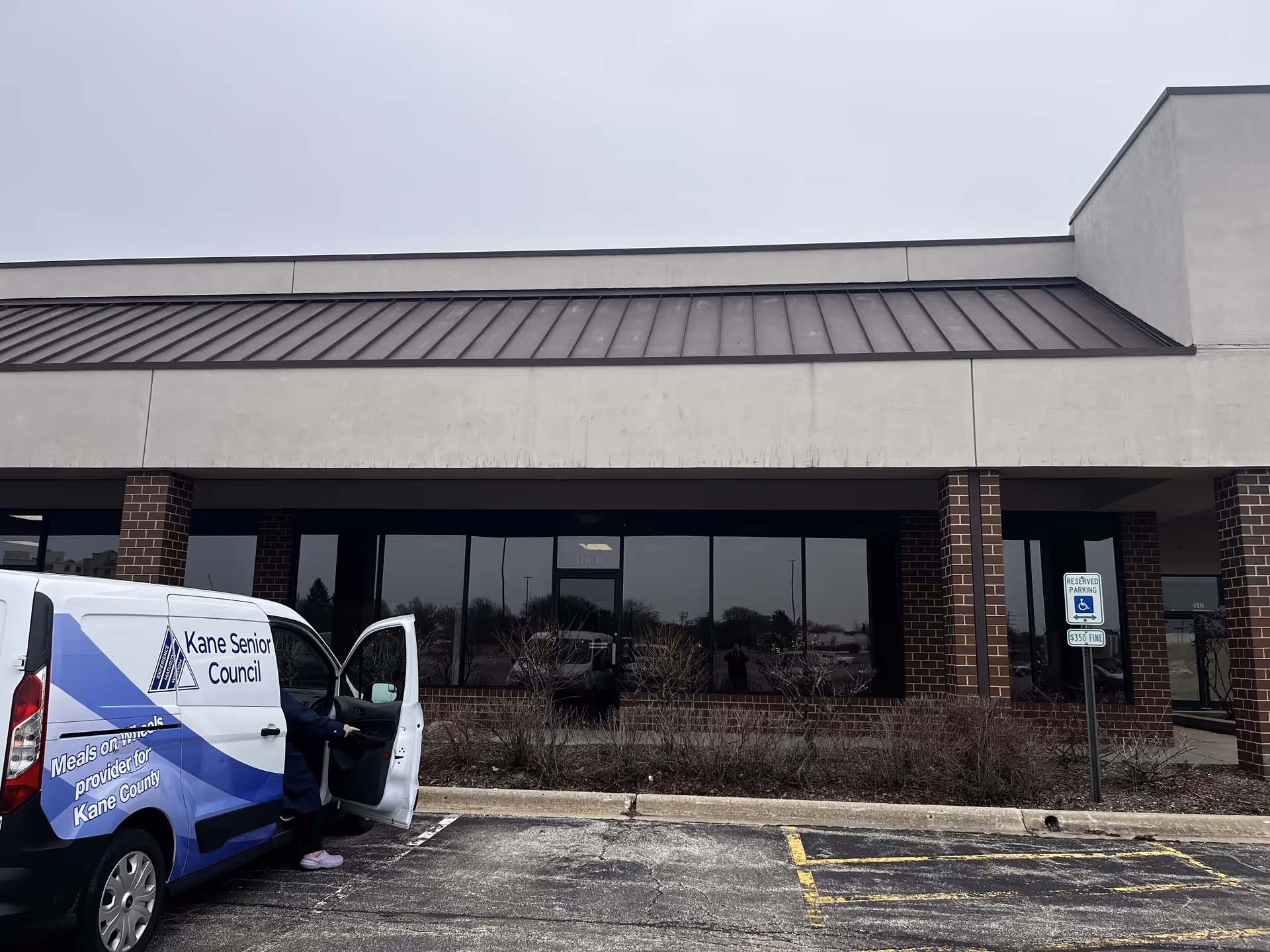 Front exterior of Kane Senior Council building with a delivery van in the parking lot.