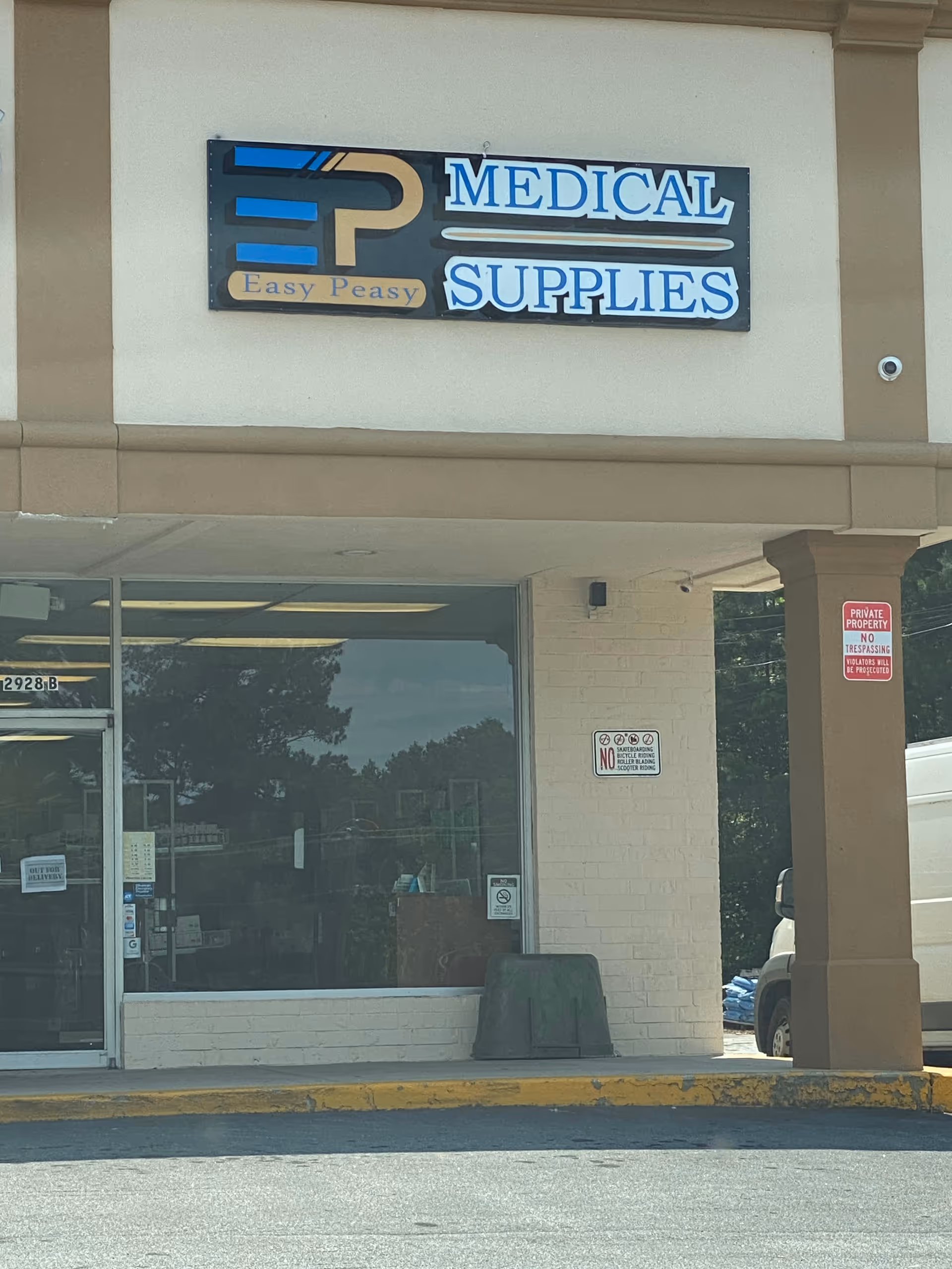 Storefront sign for Easy Peasy Medical Supplies on a beige building exterior.