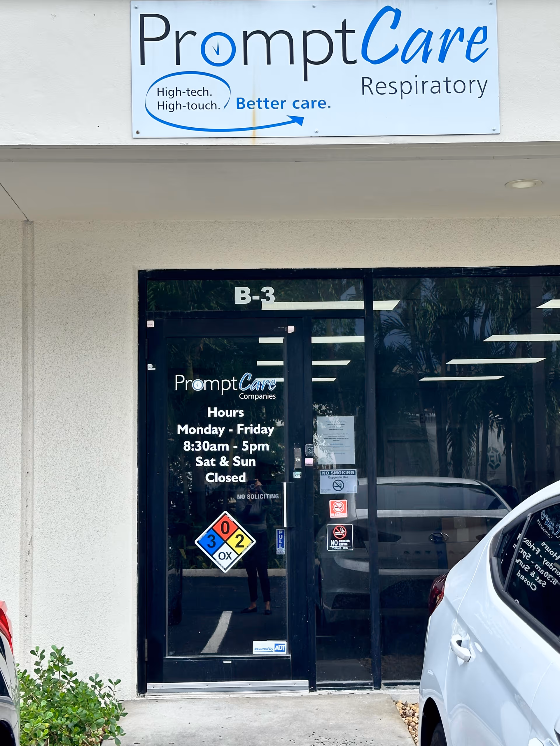 Exterior view of PromptCare Respiratory entrance with glass doors and hours posted.