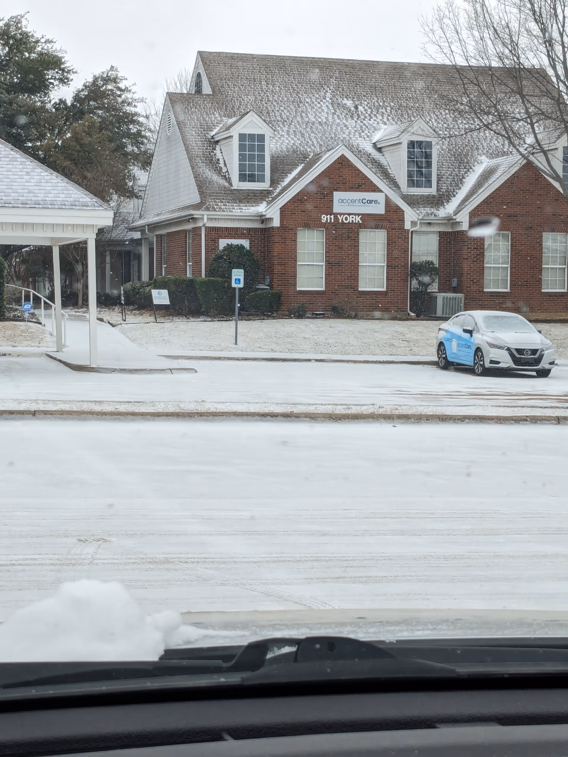 Exterior view of AccentCare building with a parked car on a snowy day.
