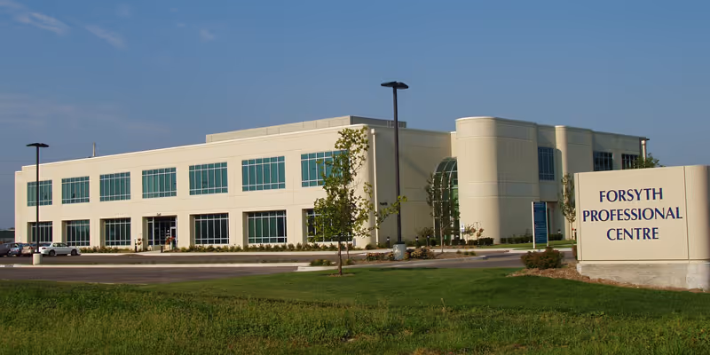 Modern two-story clinic building with large windows and a Forsyth sign.