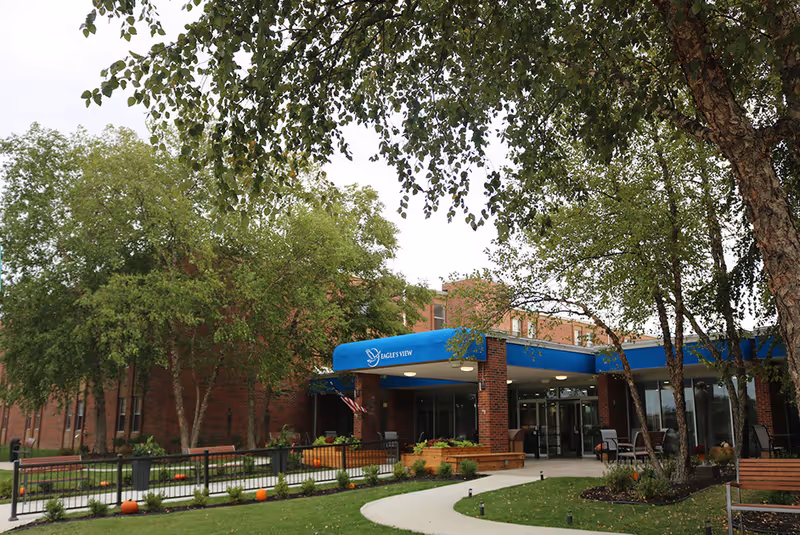 Exterior view of Eagle's View Supportive Living and Memory Care entrance with blue awning.