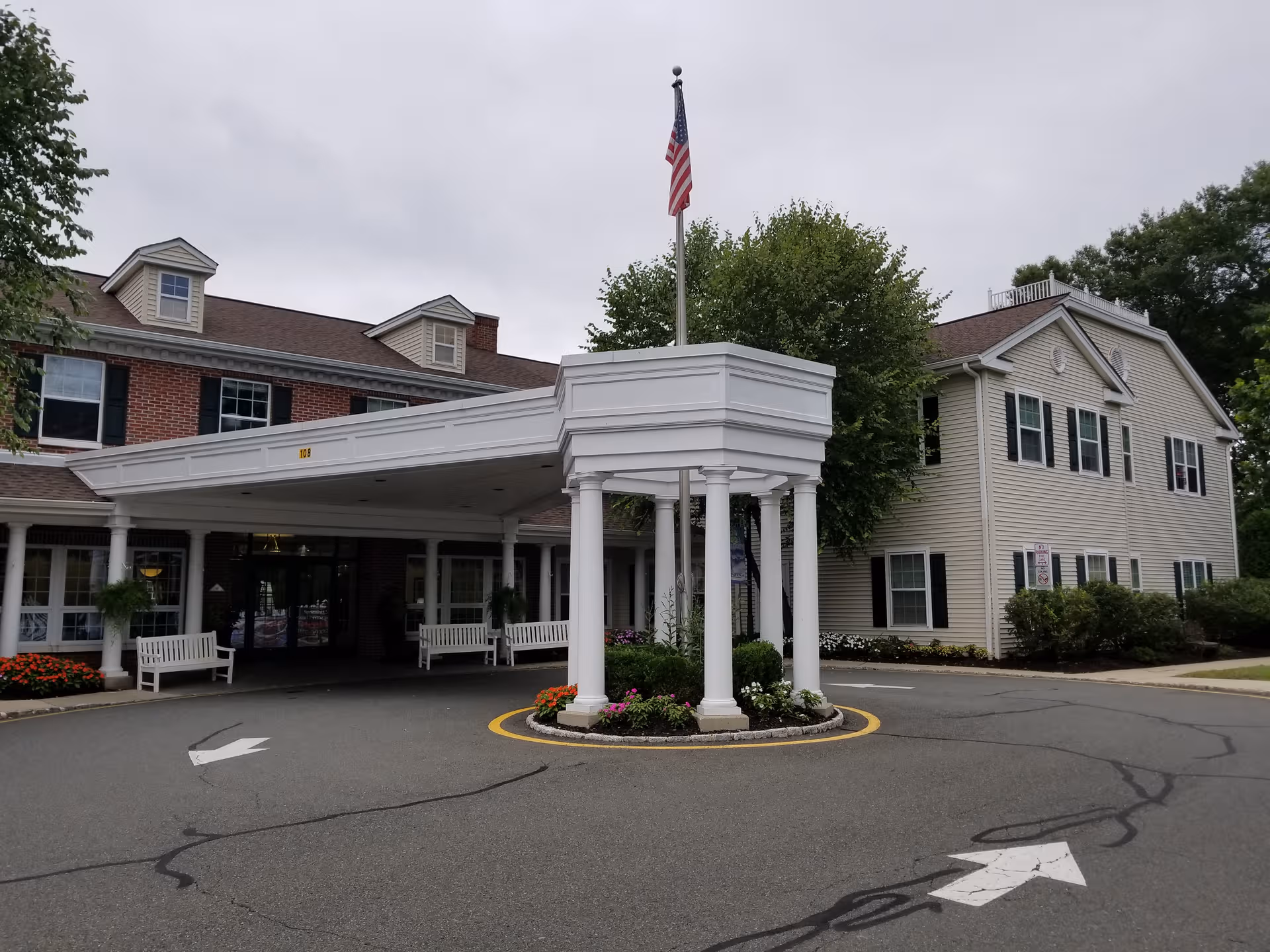 Juniper Village at Chatham exterior: front entrance with white portico and circular drive.