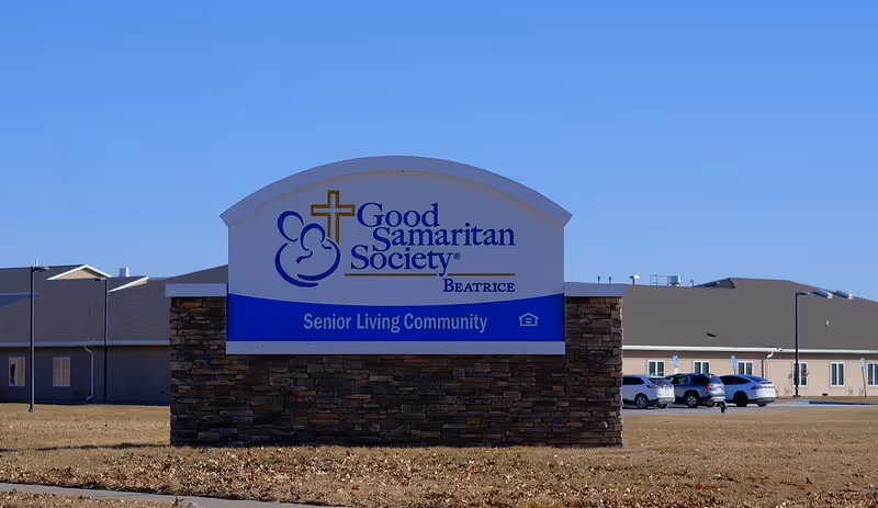 Exterior view of Good Samaritan Society Beatrice Senior Living Community sign and adjacent building.