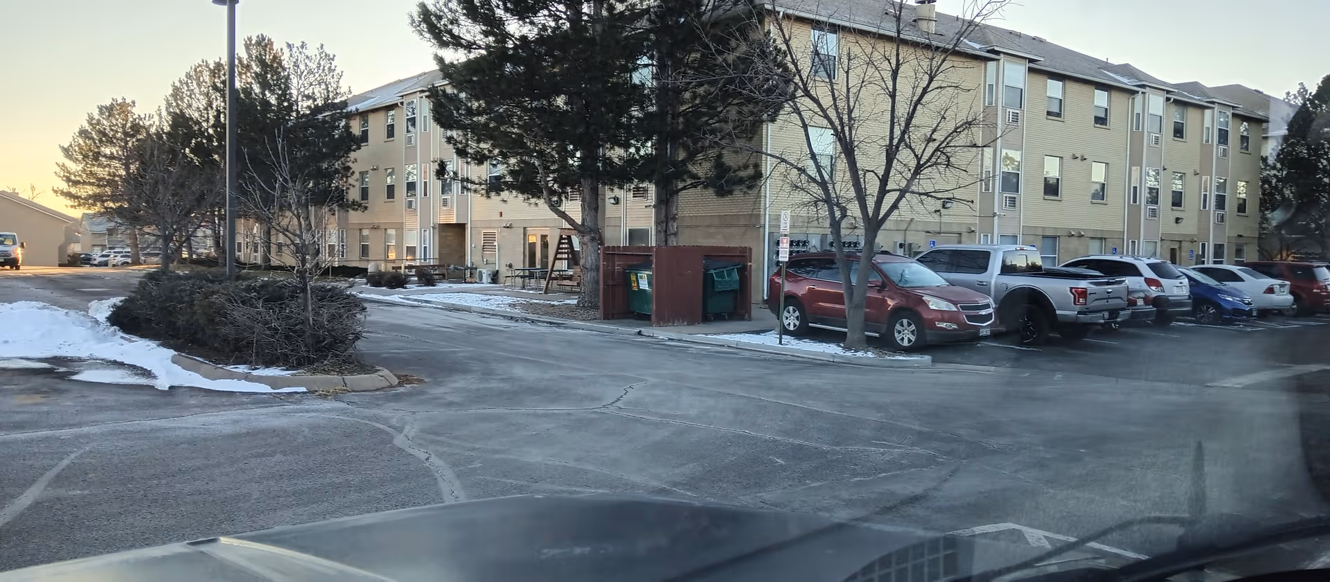 Exterior view of Silvercrest Senior Residence with parked cars and snow.