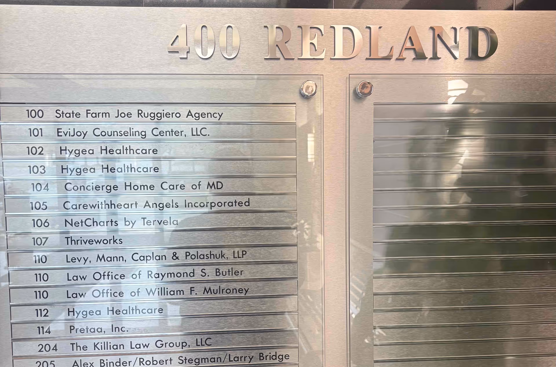 Metal building directory plaque listing tenants, including Concierge Home Care of MD, at 400 Redland.