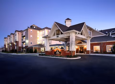 Exterior view of The Reserve at Greenbrier assisted living facility with a covered entrance.