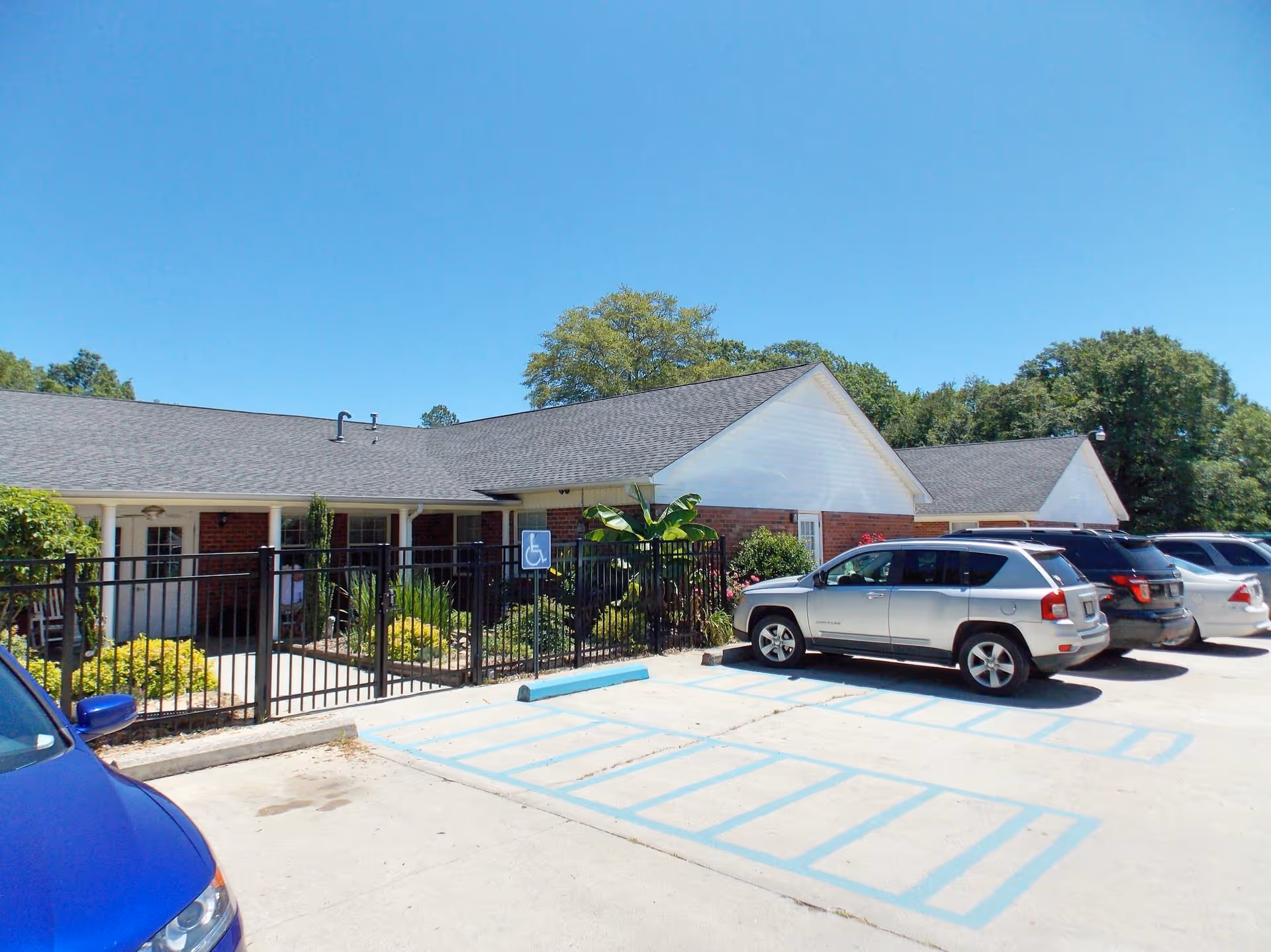 Exterior view of Heath Springs Residential Care, a single-story brick building with a parking lot.