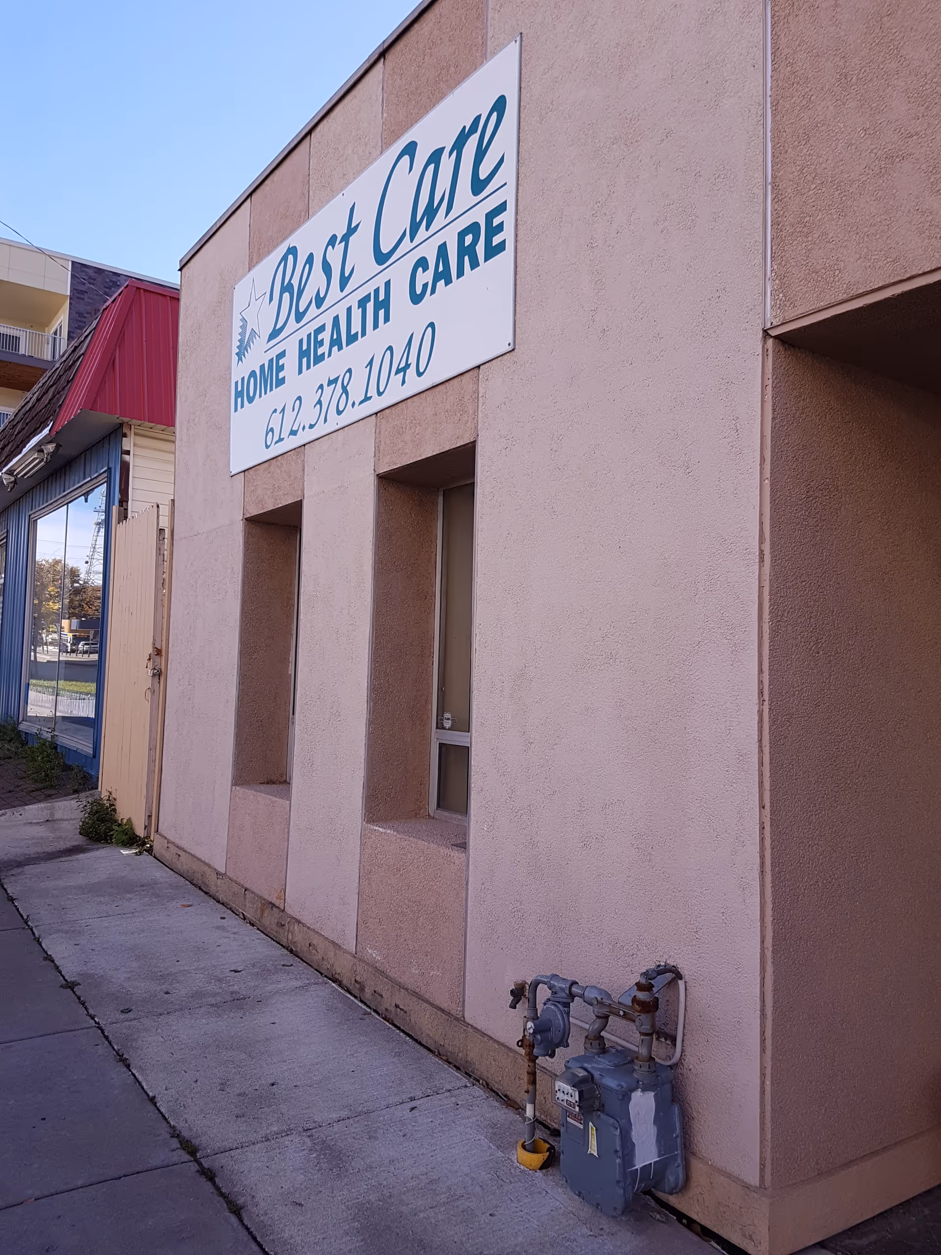 Exterior of Best Care Home Health Care building with sign along sidewalk.