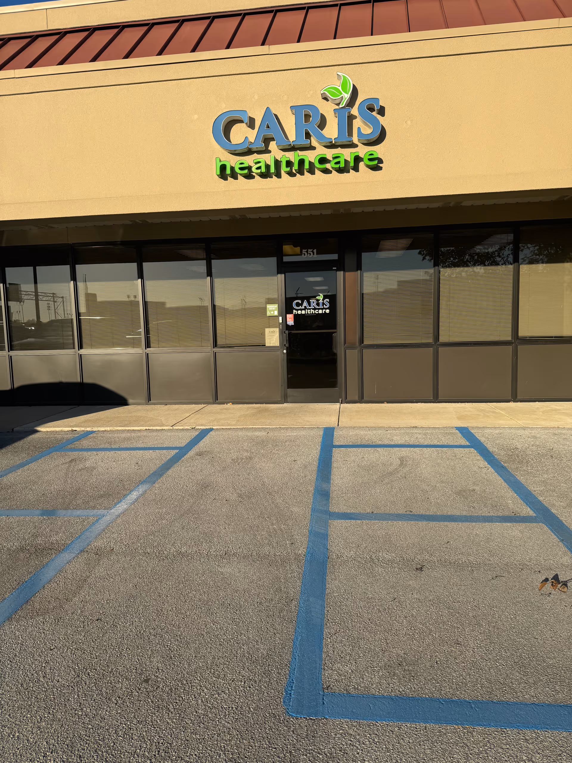 Front exterior of Caris Healthcare building with a large logo above the entrance.