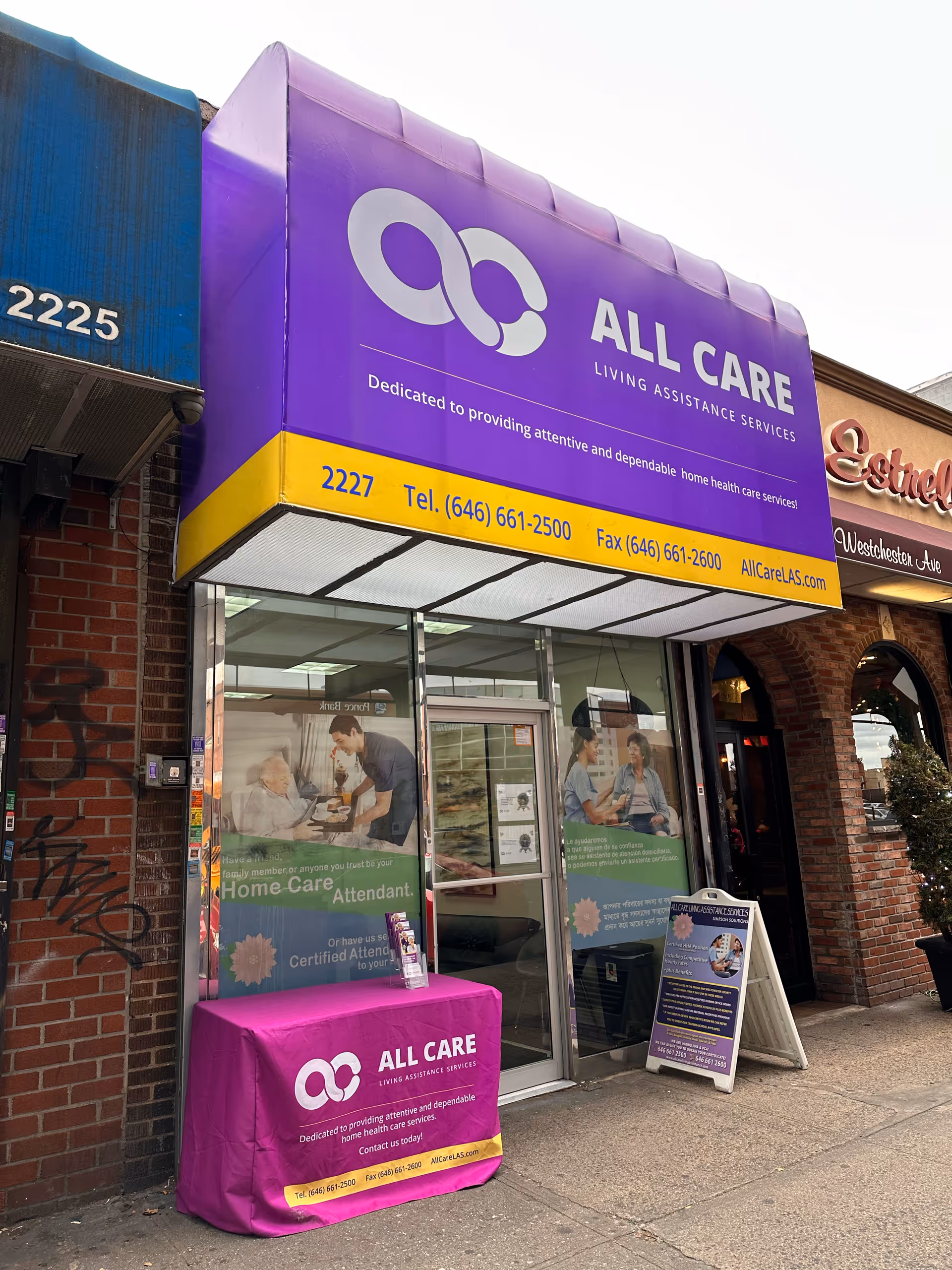 Purple storefront sign for All Care Living Assistance Services above glass doors.