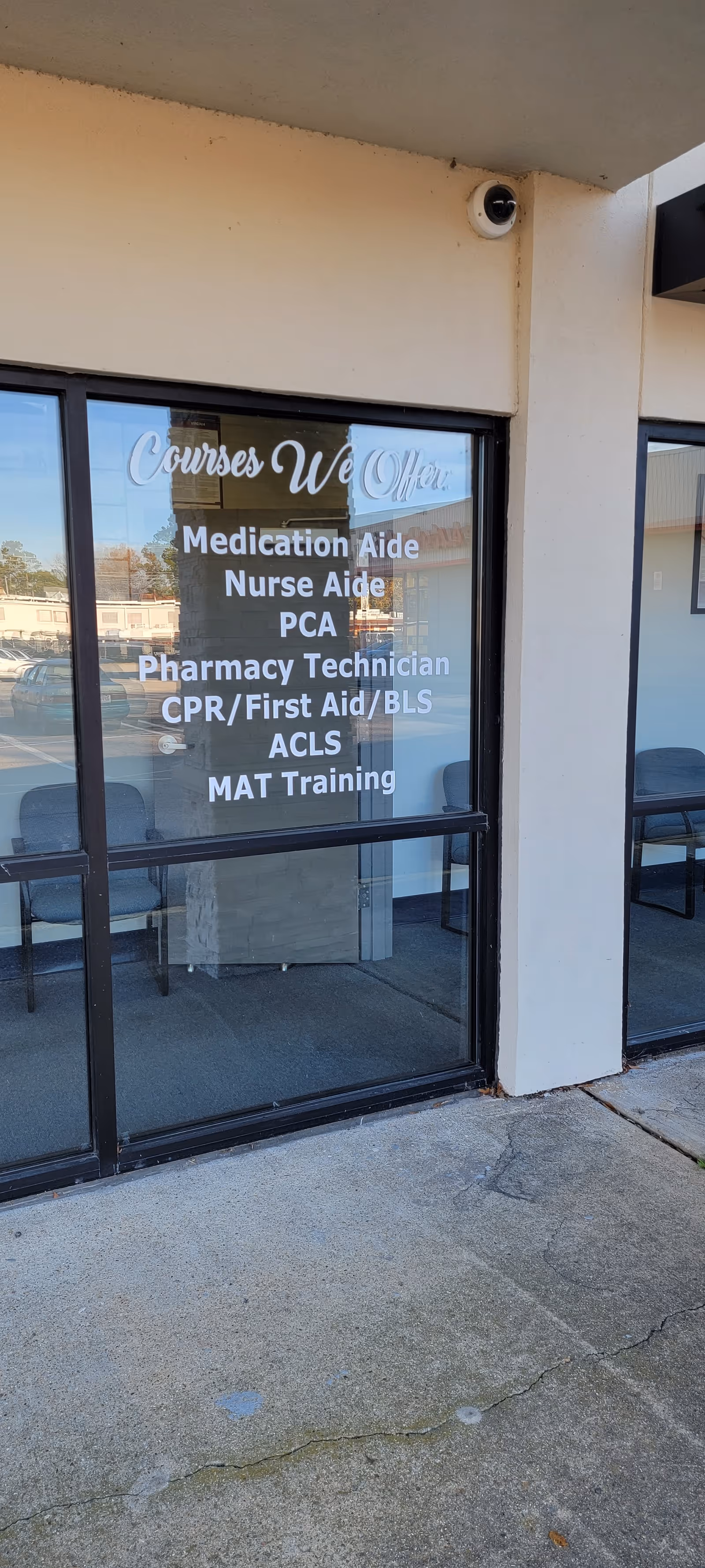 Exterior facility entrance with a glass door listing offered courses.