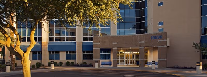 Exterior view of a modern medical building entrance with glass walls.