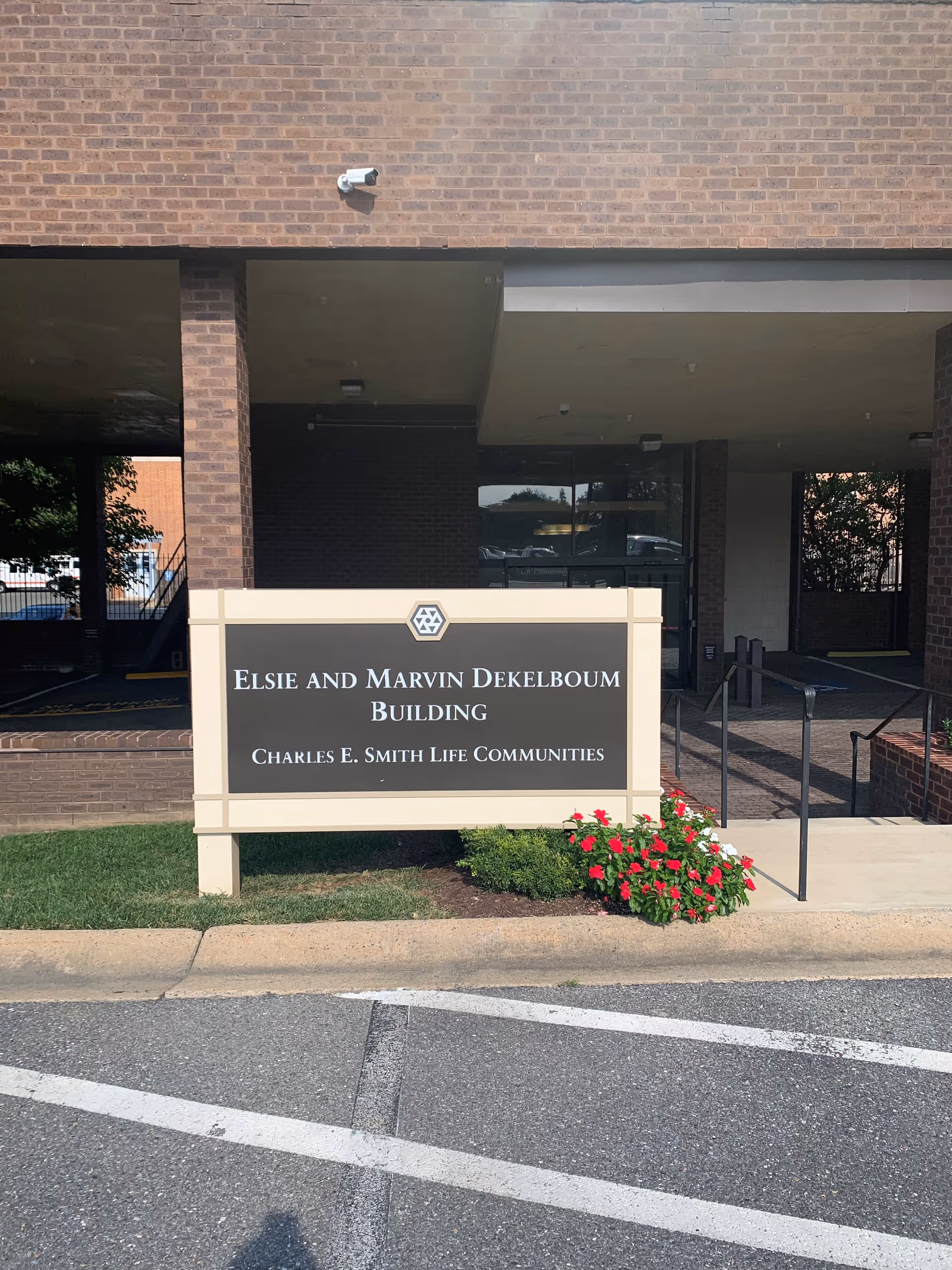 Brick building entrance with a sign reading Elsie and Marvin Dekelboum Building.