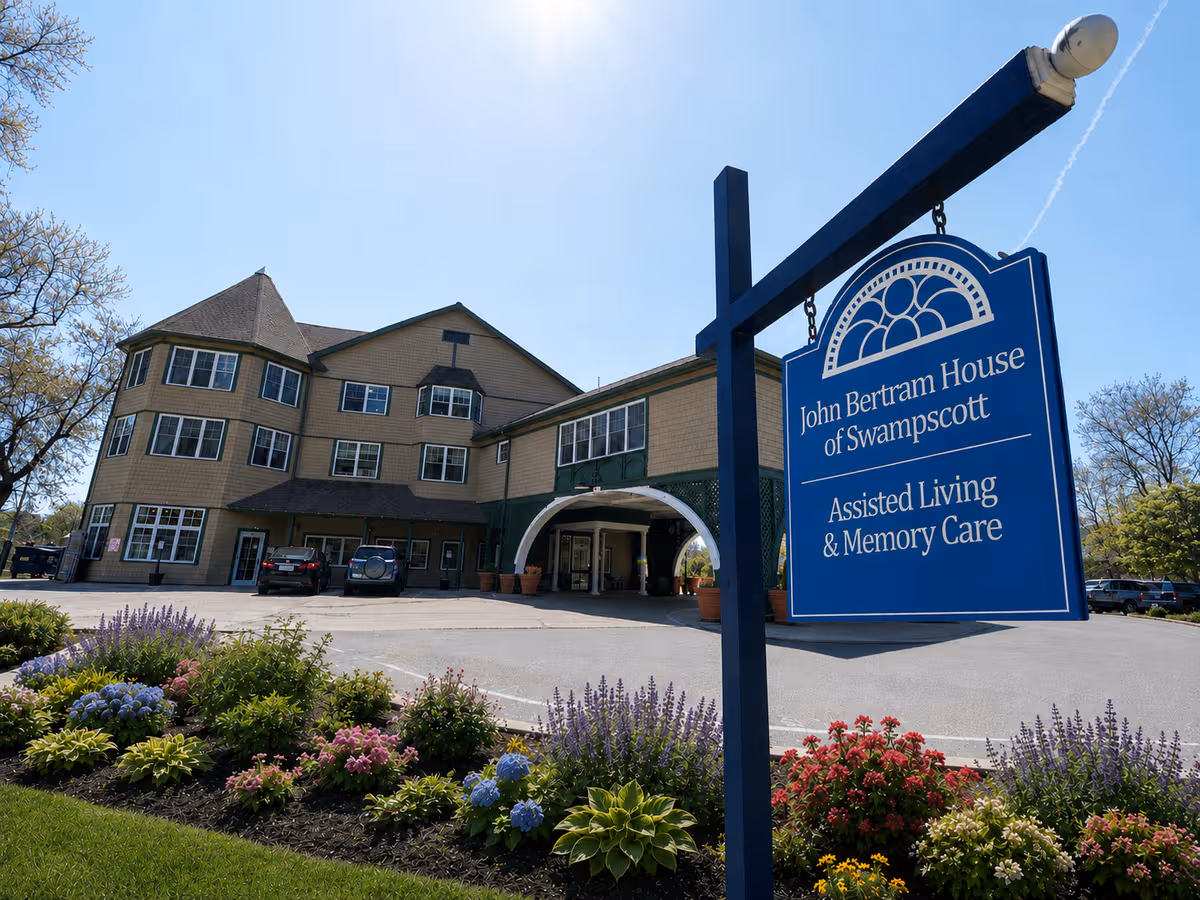 Exterior view of John Bertram House of Swampscott with front entrance, sign, and landscaping.