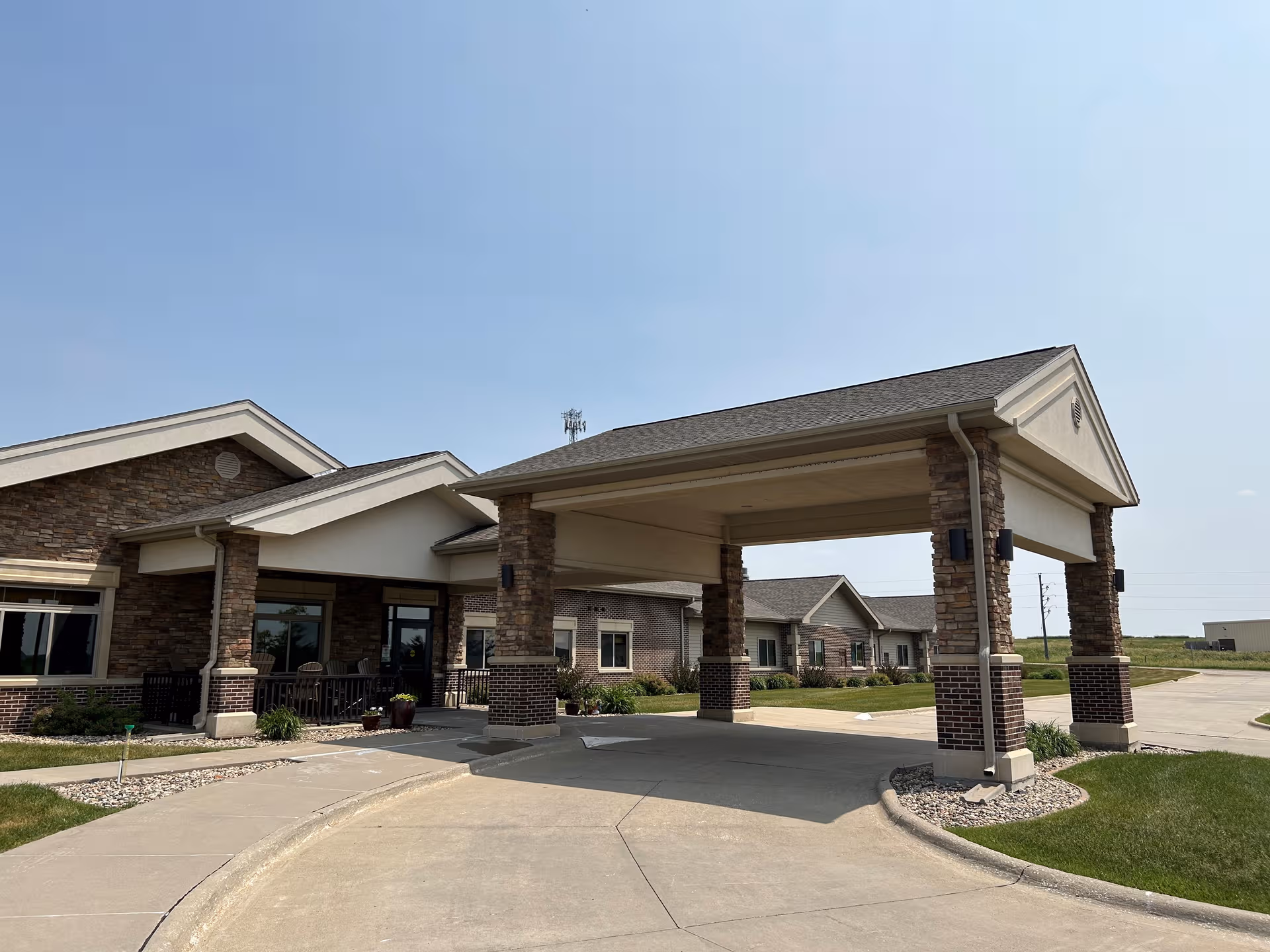 Exterior view of Bavarian Meadows Assisted Living entrance with a covered drive.
