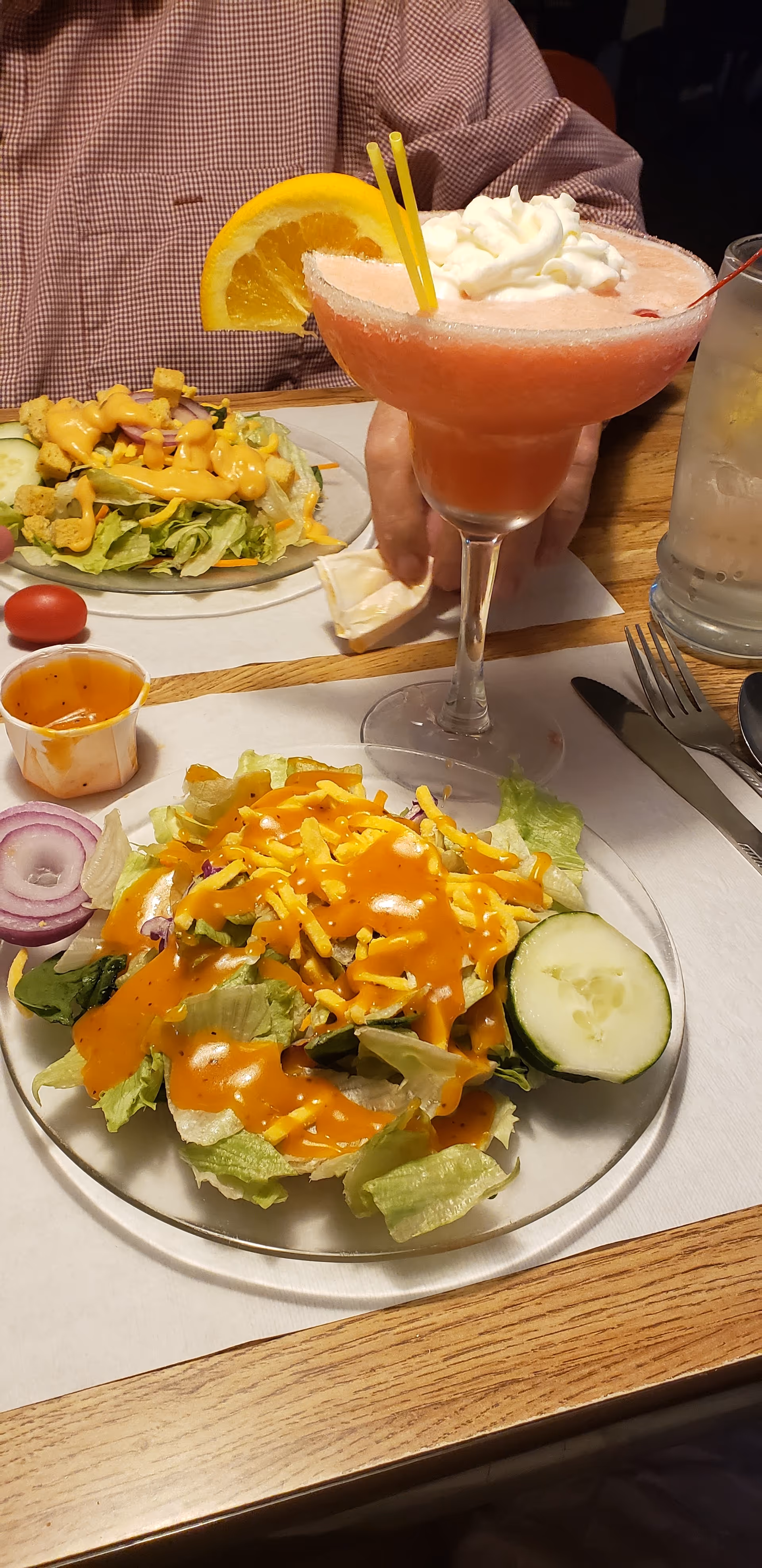 El Dorado Manor Nursing Home dining room table with salads and a pink cocktail.