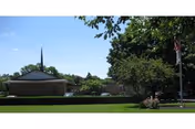 Exterior view of Lebanon Valley Home with a manicured lawn and trees.