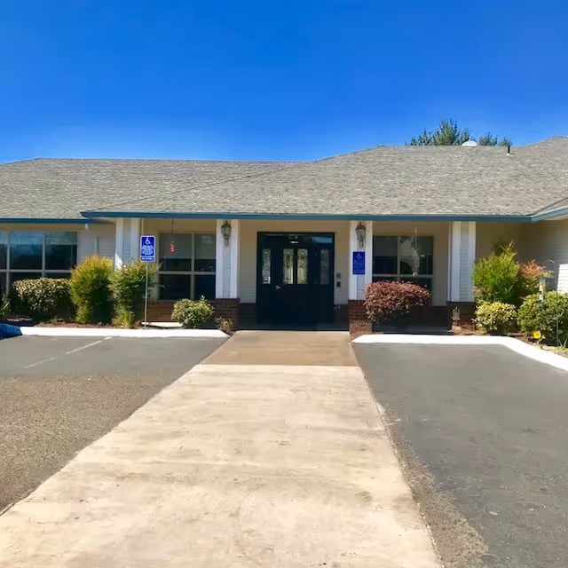 Facade of Evergreen Court of Molalla, front entrance with wheelchair-accessible signs.