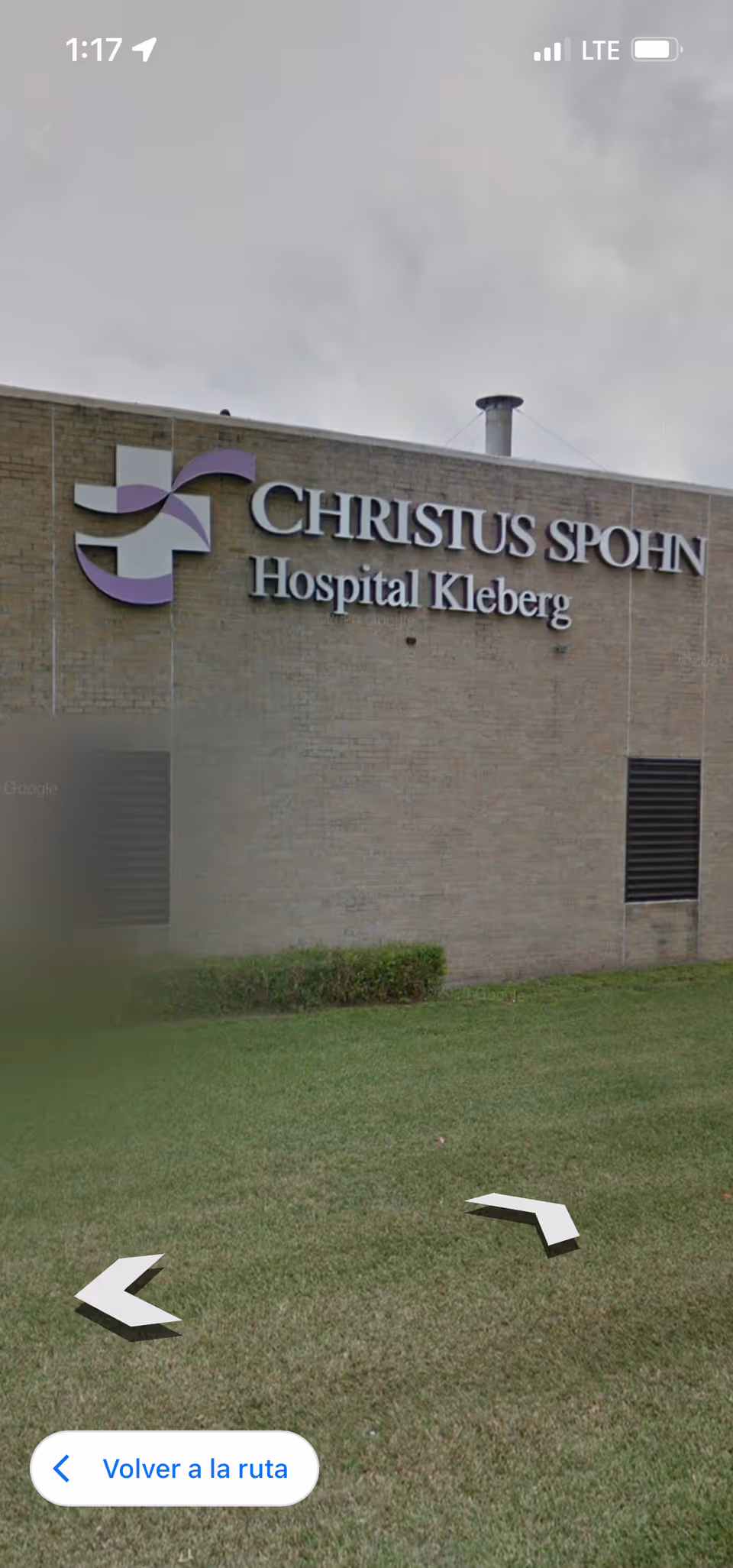 Exterior view of CHRISTUS SPOHN Hospital Kleberg building with purple logo and green lawn.