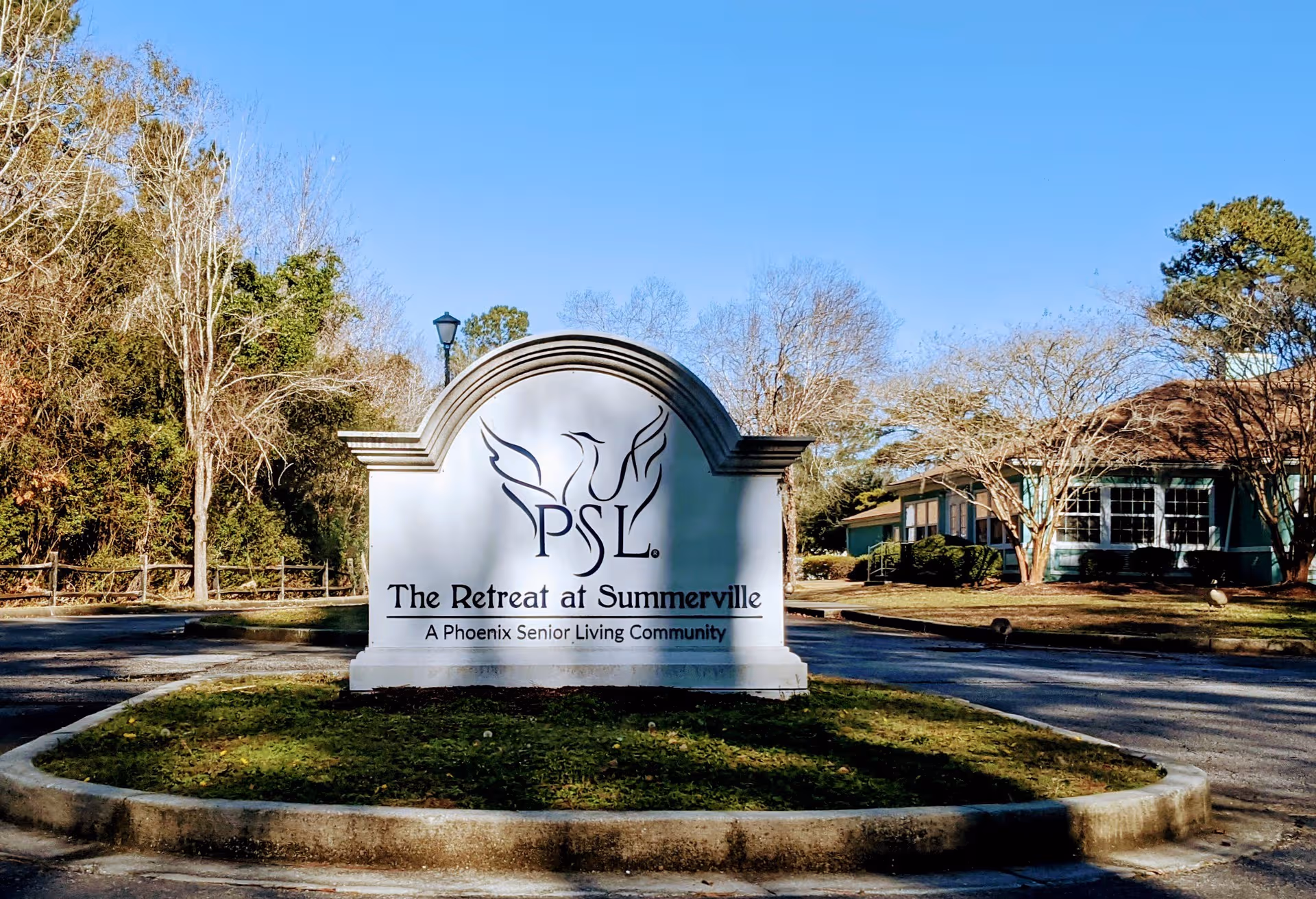 Outdoor sign for The Retreat at Summerville with building and trees in background