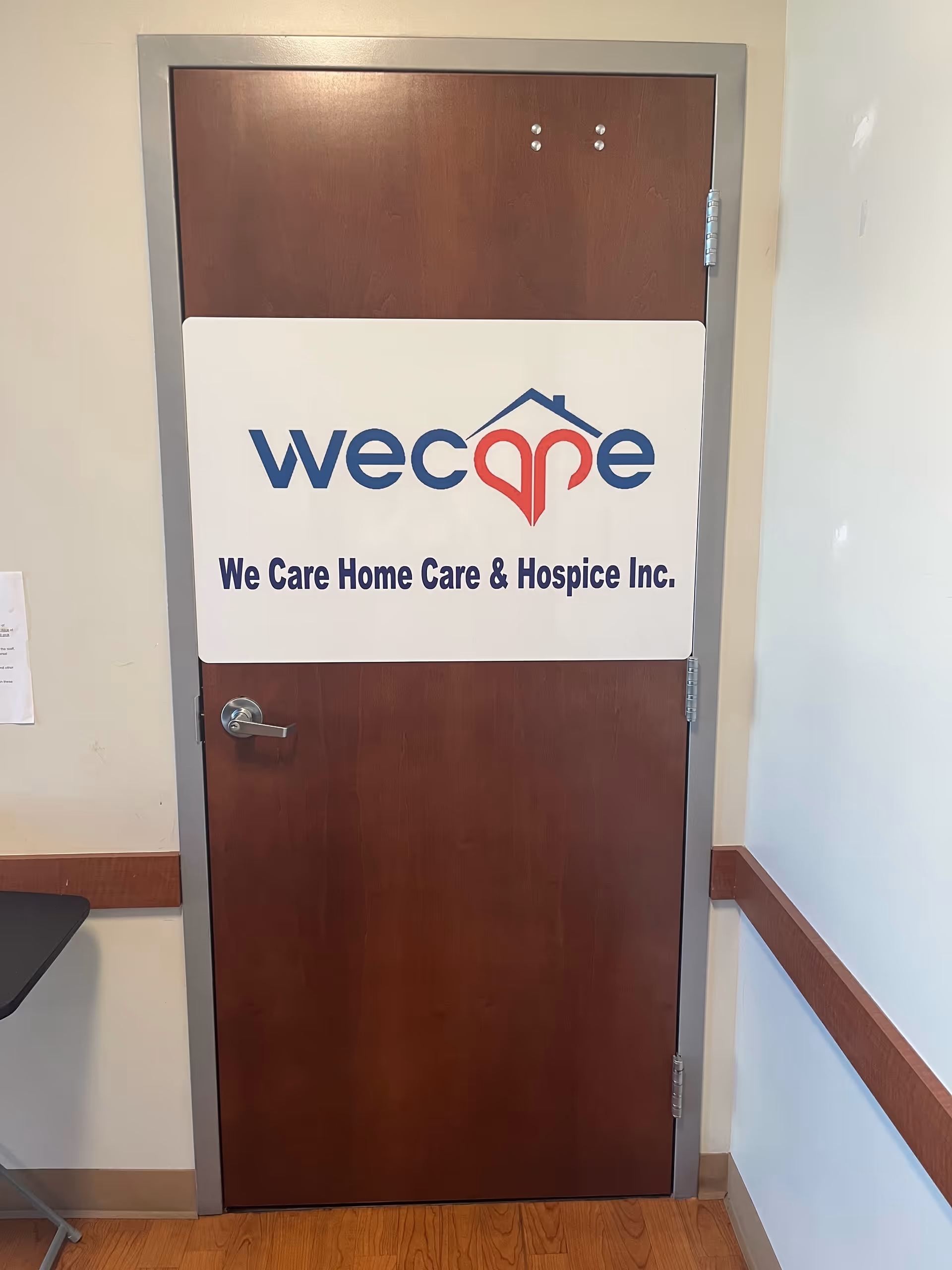 Wooden interior door with large sign for We Care Home Care & Hospice Inc.