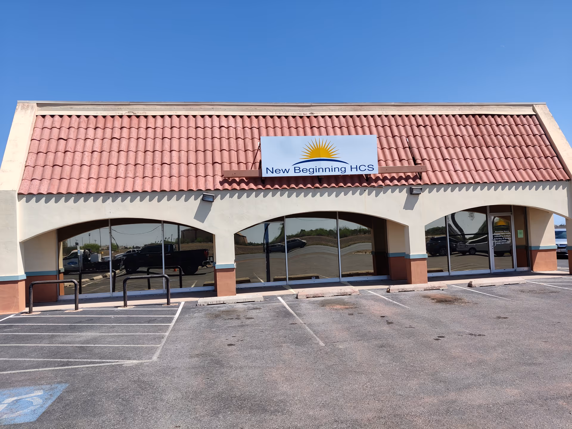 Front view of New Beginning HCS facility with red-tiled roof and arched windows.