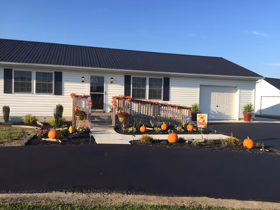 Front exterior of Paradise Senior Living with pumpkin decorations along the walkway