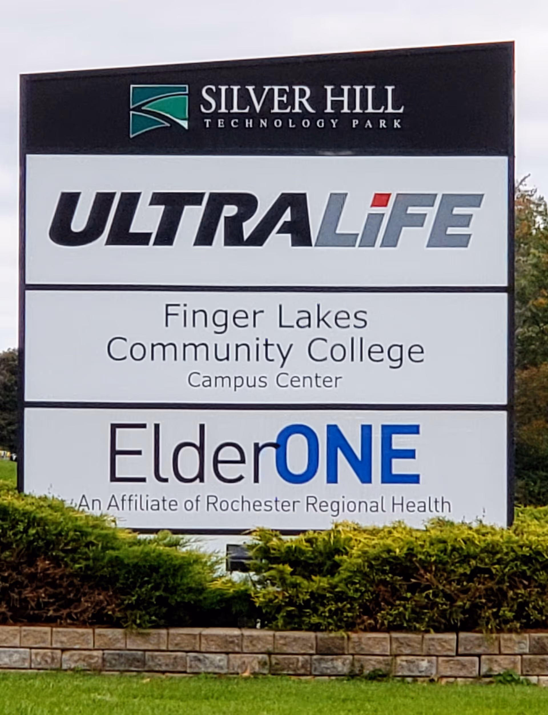 Large exterior sign displays ElderONE and Ultralife logos with landscaping in front.
