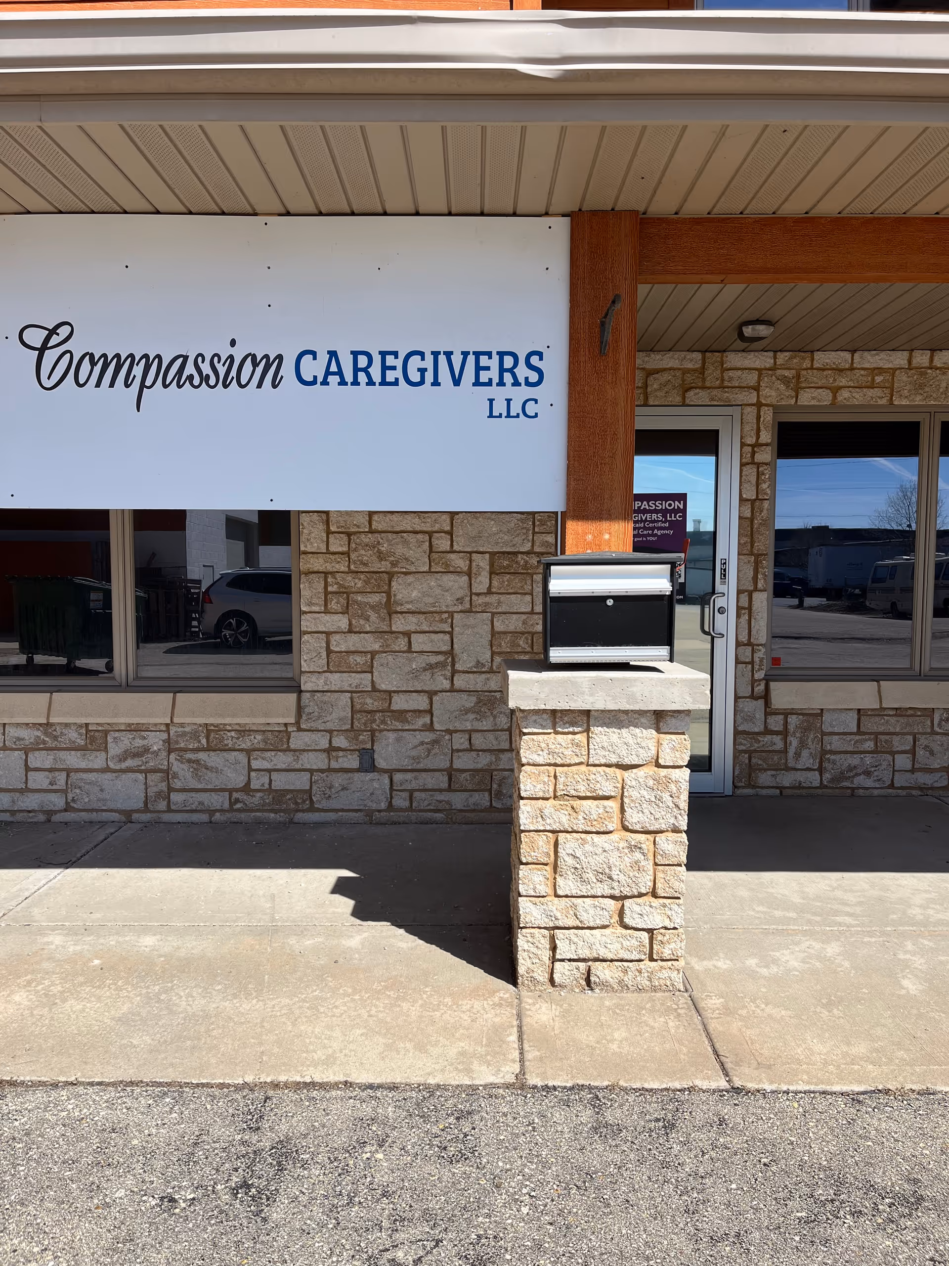 Exterior view of Compassion Caregivers LLC storefront with stone facade and sign.