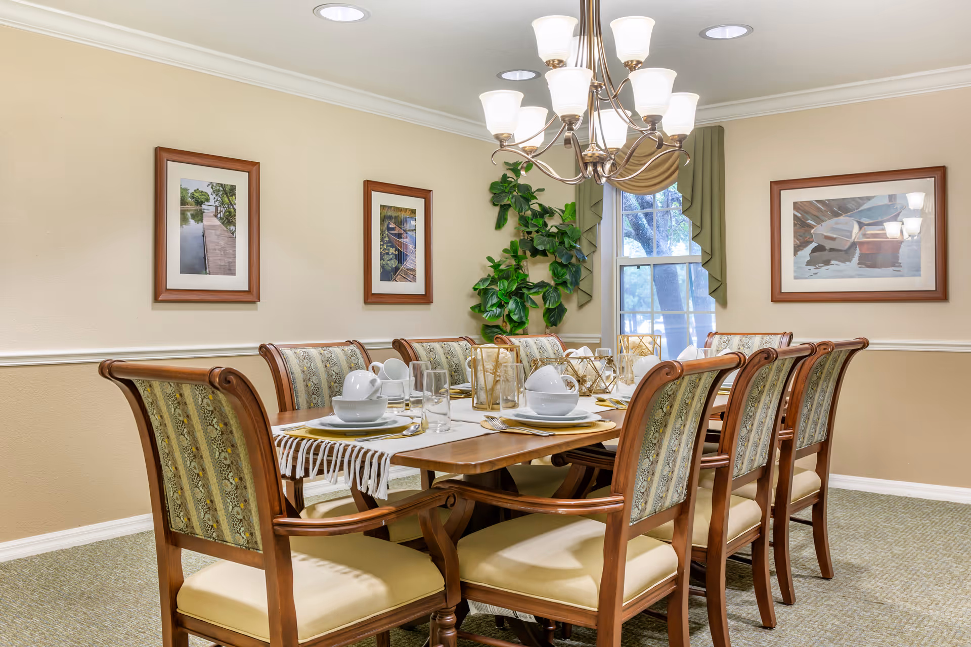 Elegant dining room with a long wooden table set for a meal and chandelier.