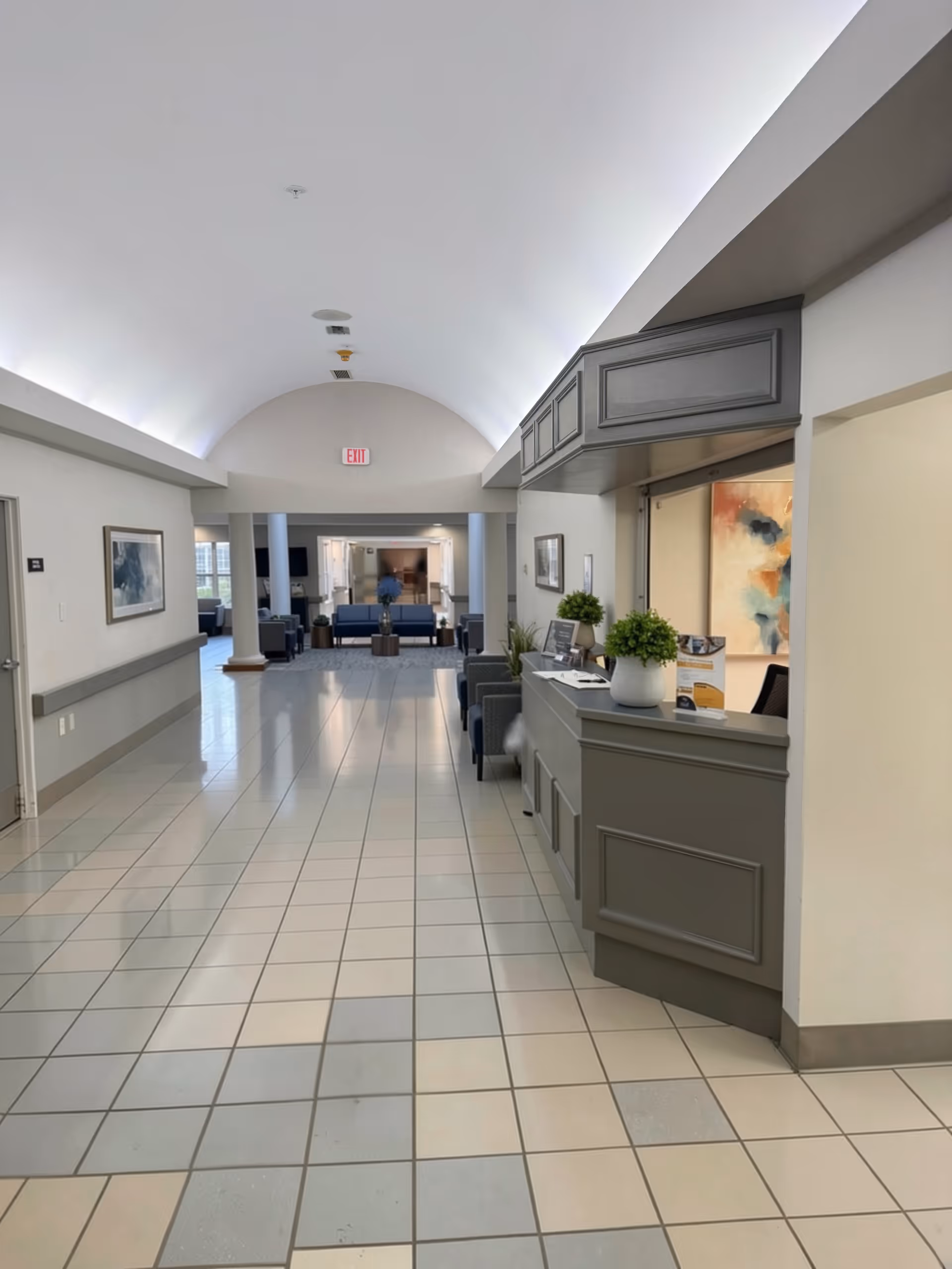 CareCore at Mentor lobby with reception desk, seating, and arched ceiling.