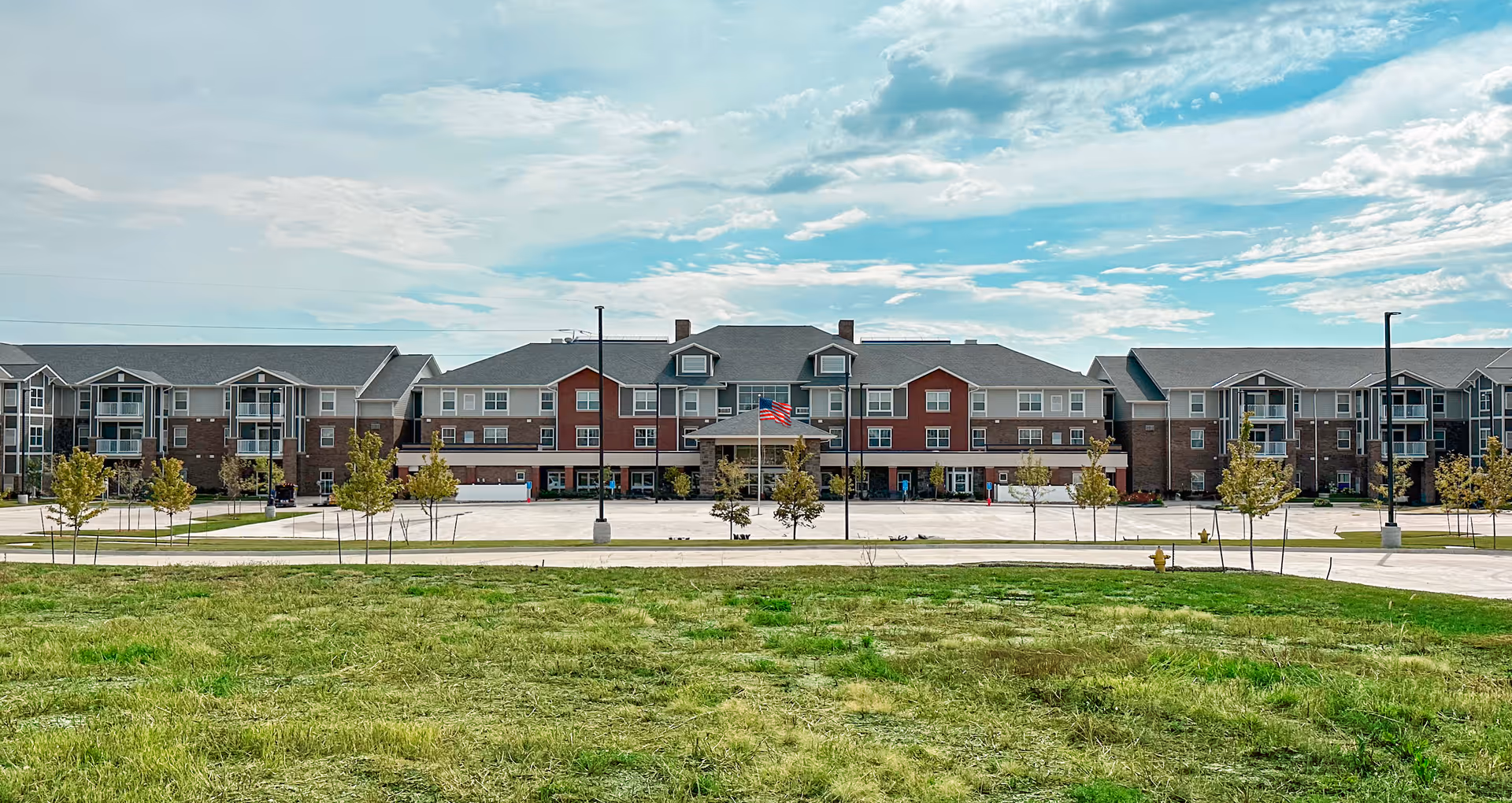 Exterior view of Glen Meadows senior living facility with parking and landscaping