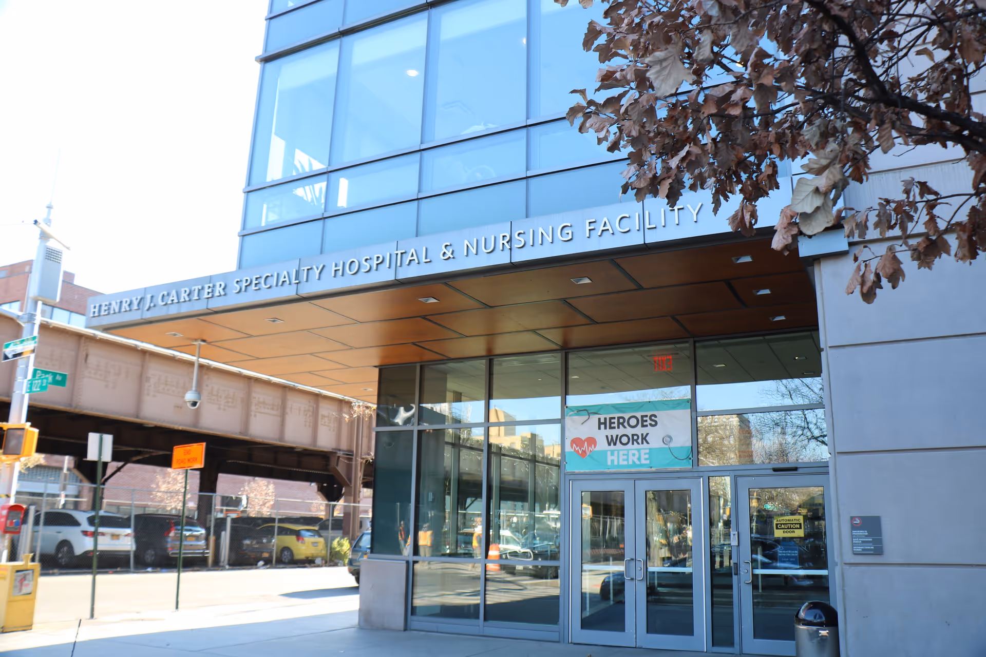 Exterior view of Henry J Carter Skilled Nursing Facility entrance with glass doors.