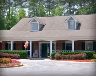 The Harbor at Douglasville exterior shows brick building, front entrance, and manicured landscaping.