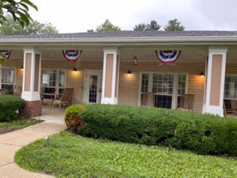 Front porch of The Wellington at Southport with rocking chairs and bunting