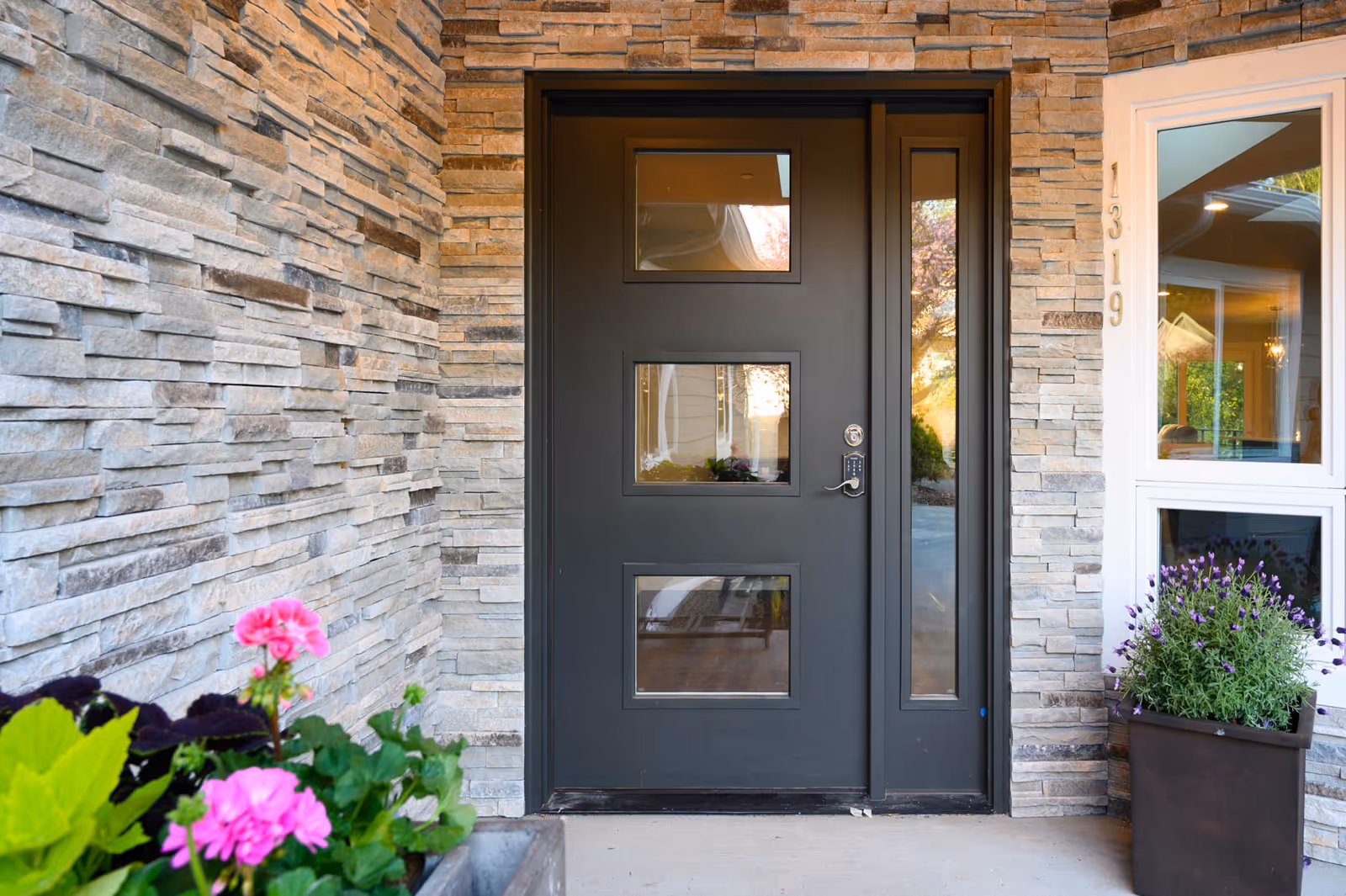 Front entrance of Cornerstone Adult Family Home with stone walls and planters.