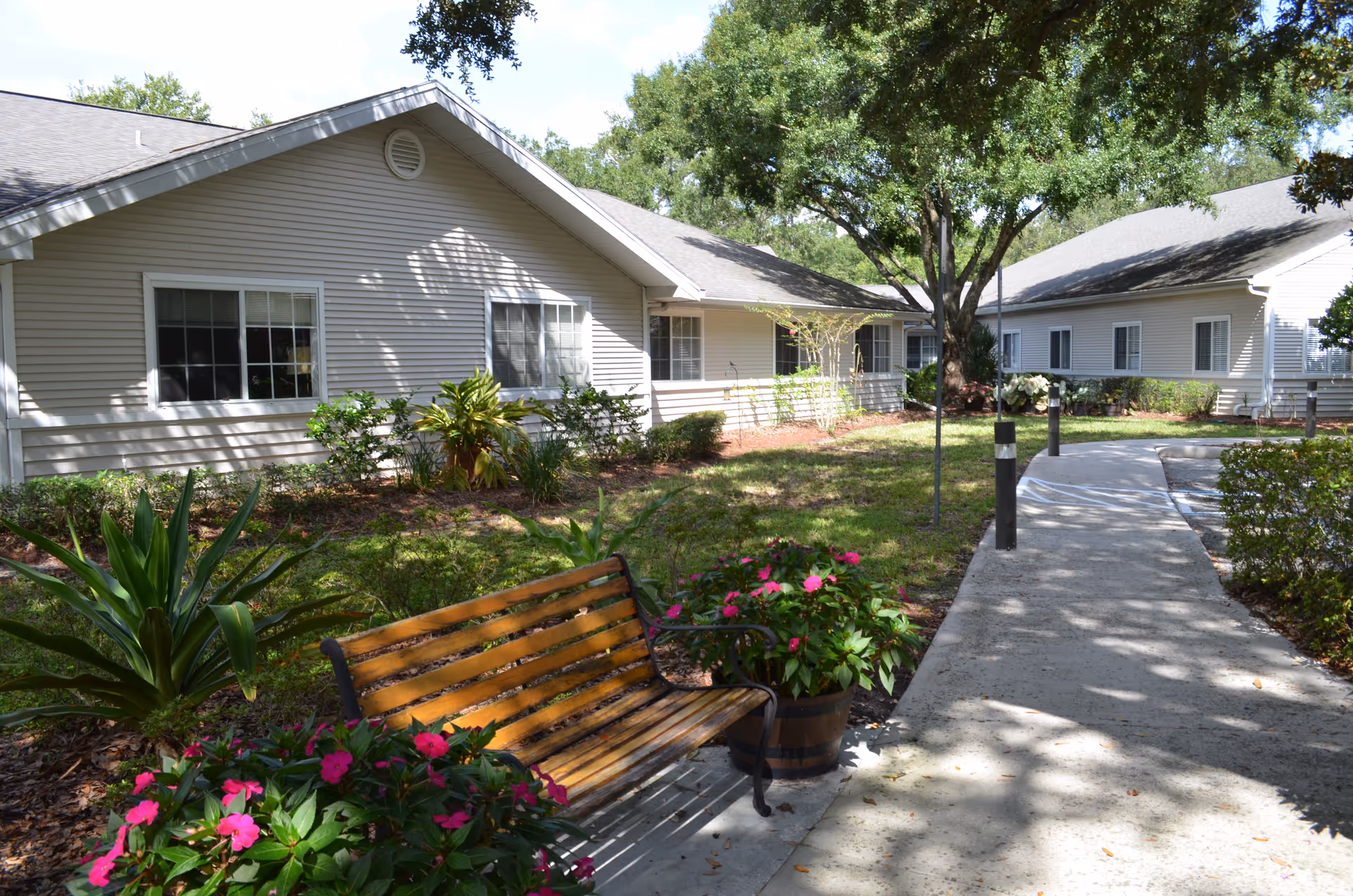Exterior view of Compass Rose of Brandon with walkway, bench, and landscaped garden.