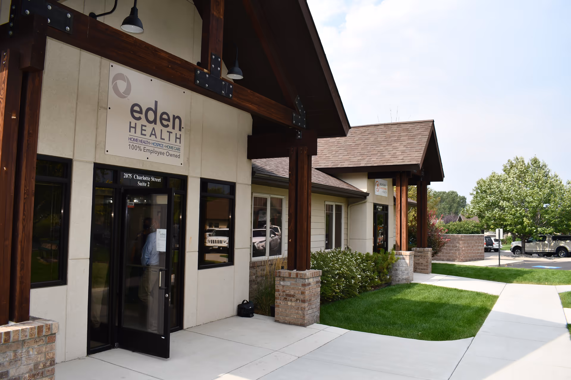 Exterior view of Eden Health building entrance with sign and landscaped walkway.
