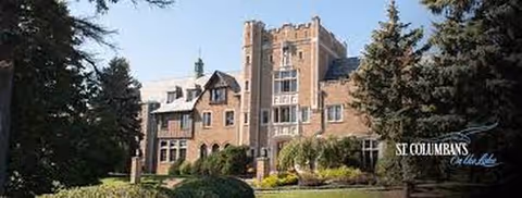 Exterior view of St Columban's on the Lake Retirement Home, brick building with manicured lawn.