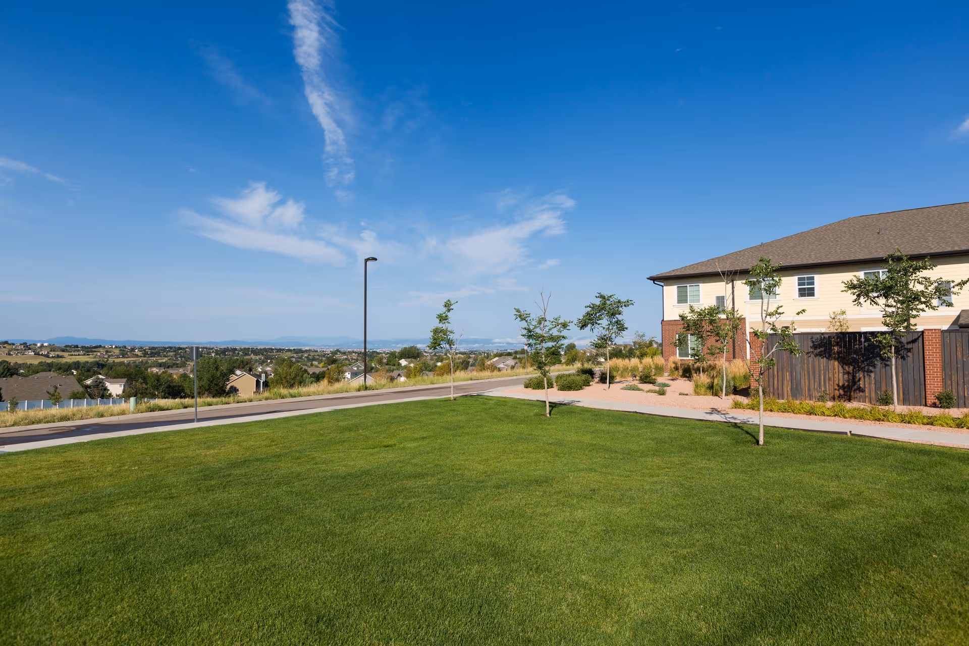 Wide view of a grassy front lawn and the Peakview Assisted Living facility.