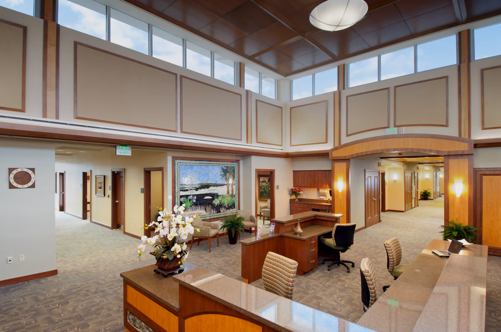 Bright hospice lobby with reception desk, seating, and hallways.