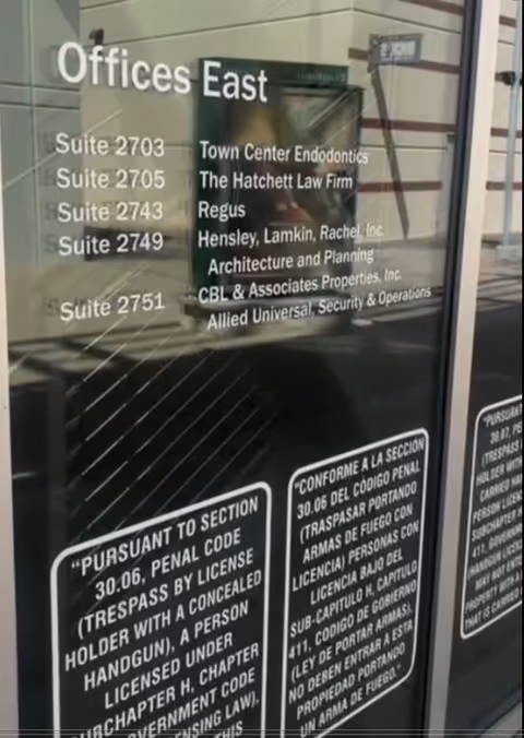 Glass door directory listing multiple office suites, including Offices East and various suite numbers.