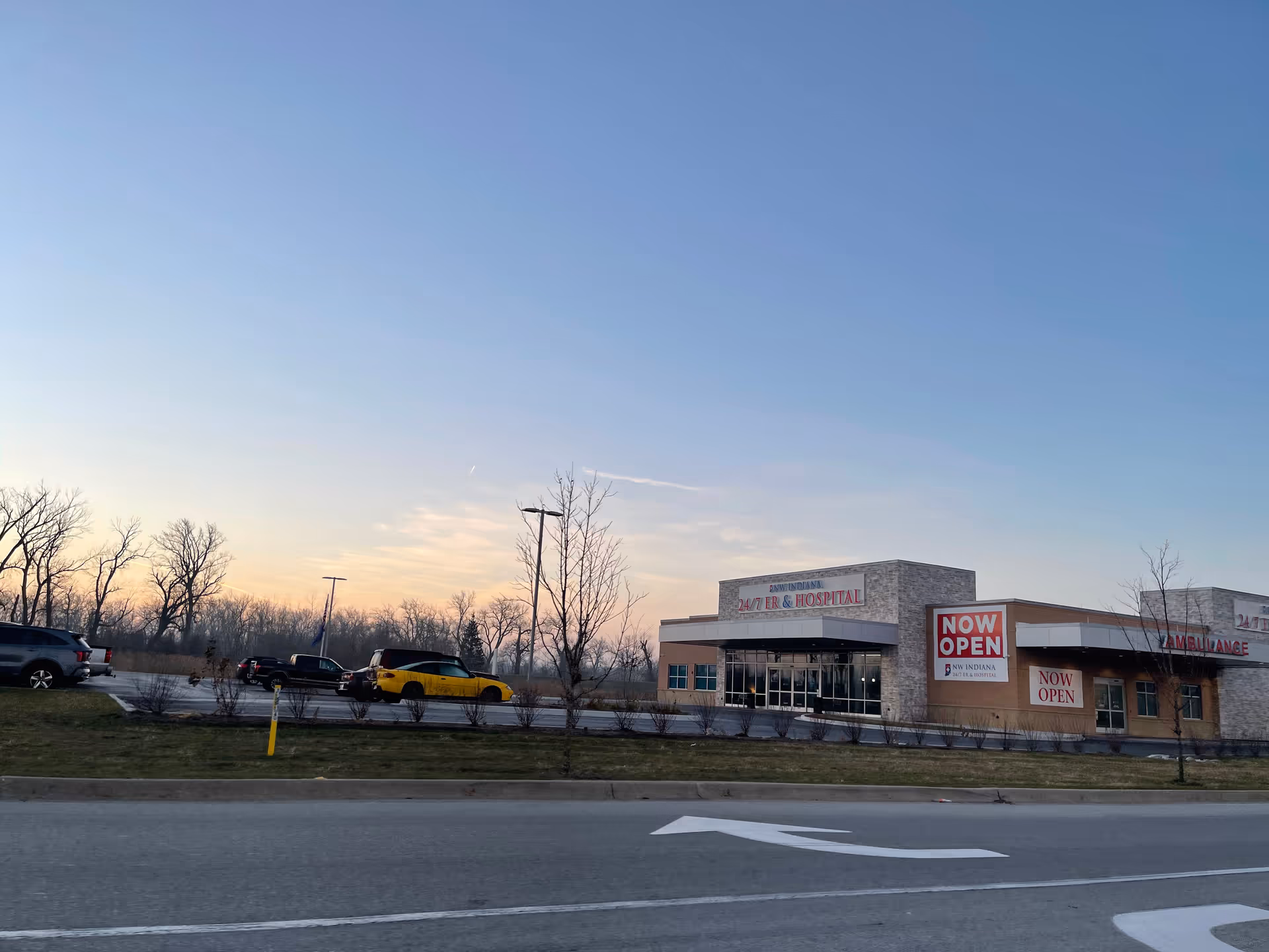 Exterior view of NW Indiana ER & Hospital building with signage and parked cars.