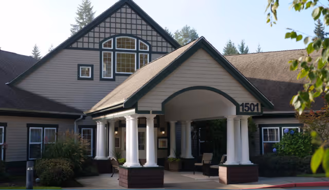 Front view of The Ridge an Encore Community building with arch entrance and white columns.