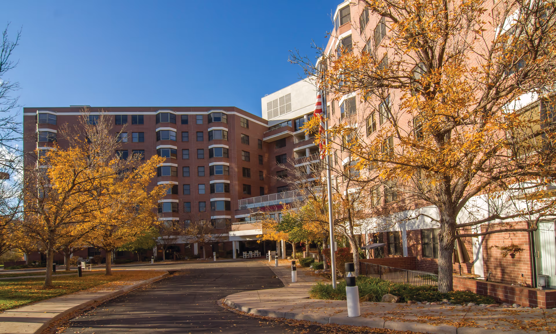 Brookdale Meridian Englewood exterior: brick building with trees and walkway
