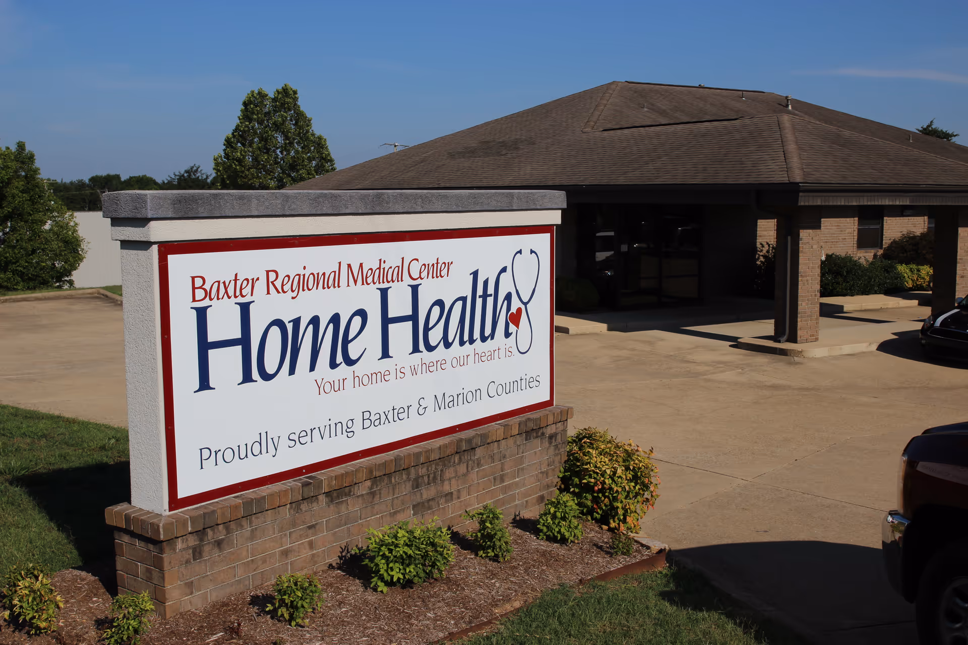 Exterior view of Baxter Regional Medical Center Home Health sign and building entrance.