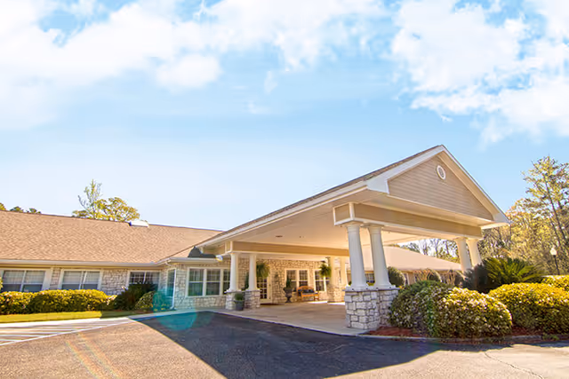 Entrance to a senior living facility with a covered front porch.